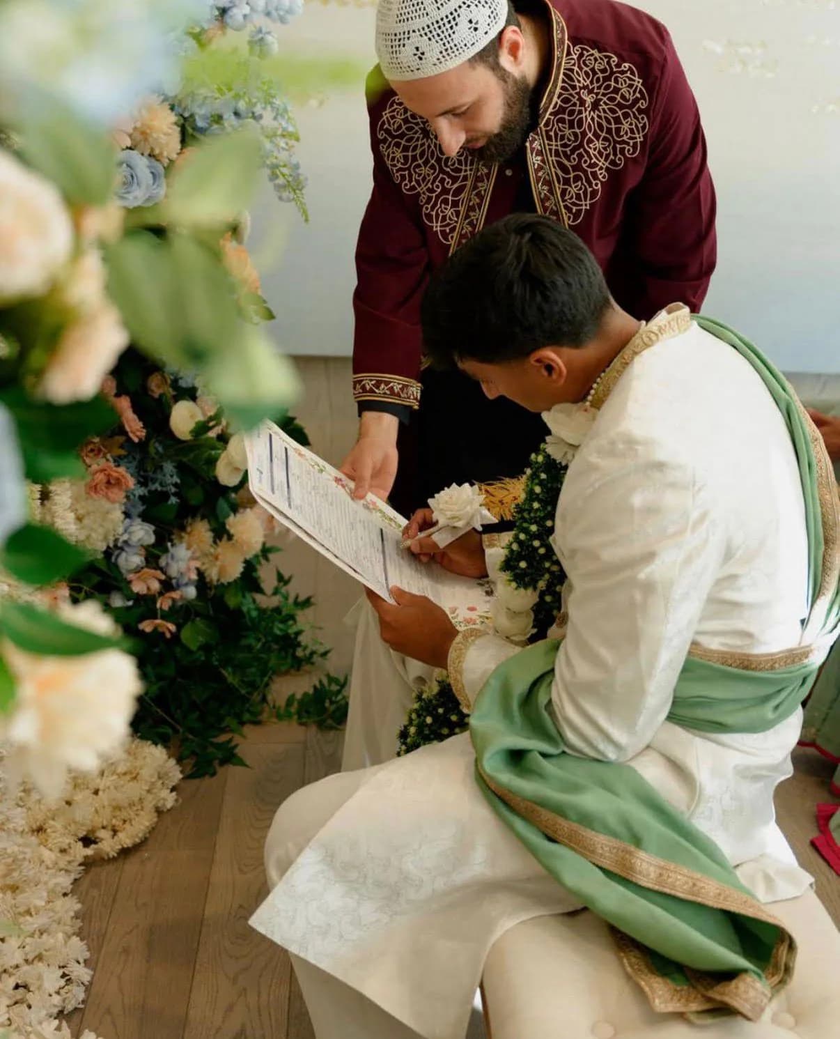 Imam Zaniar Ahmad guiding a groom through Nikah documents