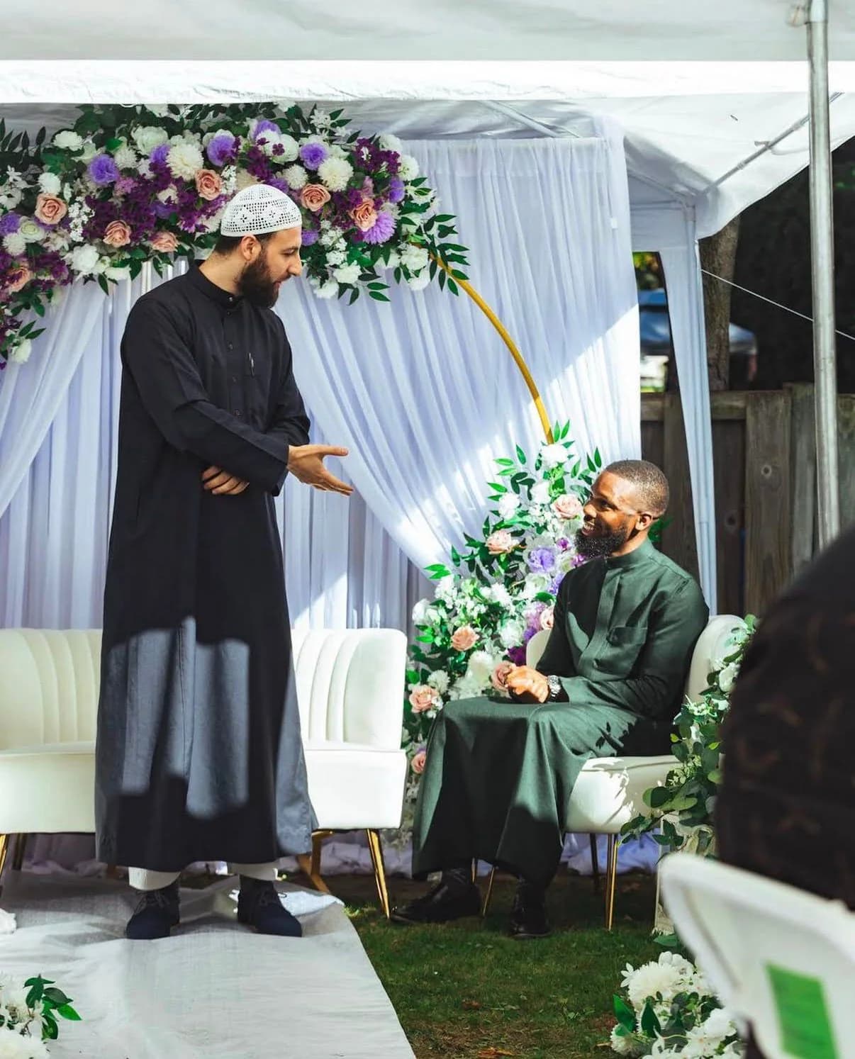 Imam Zaniar Ahmad welcoming a groom at an outdoor Nikah